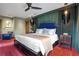 Main bedroom with king-size bed, dark wood furniture and a ceiling fan at 450 Cherokee Dr, Orlando, FL 32801