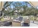 Relaxing outdoor deck with wicker furniture, offering a treetop view at 450 Cherokee Dr, Orlando, FL 32801