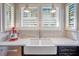 Modern kitchen with white cabinets, a farmhouse sink, and new appliances at 450 Cherokee Dr, Orlando, FL 32801