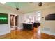 Open concept kitchen with island, white cabinets, and breakfast bar at 450 Cherokee Dr, Orlando, FL 32801