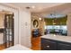 Kitchen with dining area featuring hardwood floors, breakfast nook, stylish lighting, and an expansive island at 450 Cherokee Dr, Orlando, FL 32801