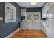 Charming galley kitchen with white cabinets and hardwood floors at 450 Cherokee Dr, Orlando, FL 32801