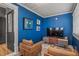 Living room featuring blue walls, modern furniture, and wood floors at 450 Cherokee Dr, Orlando, FL 32801