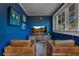 Media room with two leather chairs, TV, and blue walls at 450 Cherokee Dr, Orlando, FL 32801