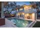 Stunning pool and patio area with hot tub at night at 450 Cherokee Dr, Orlando, FL 32801