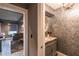 Stylish powder room with ornate vanity and decorative wallpaper at 450 Cherokee Dr, Orlando, FL 32801