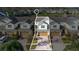 Aerial view of two-story townhome with driveway and community lake in background at 564 Woodland Terrace Blvd, Orlando, FL 32828