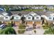 Row of townhouses with attached garages, near a lake at 564 Woodland Terrace Blvd, Orlando, FL 32828