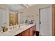 Bathroom featuring double sink vanity, a large mirror, and a walk-in shower at 564 Woodland Terrace Blvd, Orlando, FL 32828