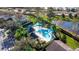 Aerial view of community pool with shade sails and lounge chairs at 564 Woodland Terrace Blvd, Orlando, FL 32828