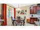 Cozy dining area with an ornate table and chairs, adjacent to the kitchen at 564 Woodland Terrace Blvd, Orlando, FL 32828