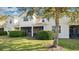 Two-story townhome with screened patio, lush landscaping, and grassy backyard at 564 Woodland Terrace Blvd, Orlando, FL 32828