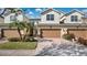 Two-story townhome with attached garage and landscaped front yard at 564 Woodland Terrace Blvd, Orlando, FL 32828
