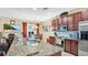 A kitchen with granite countertops, stainless steel appliances and a view to the dining room at 564 Woodland Terrace Blvd, Orlando, FL 32828