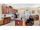 A kitchen featuring wood cabinets, stainless steel appliances, and granite countertops with barstool seating at 564 Woodland Terrace Blvd, Orlando, FL 32828