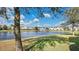 Community lake with fountain, lush green space, and townhomes in background at 564 Woodland Terrace Blvd, Orlando, FL 32828
