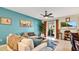 Spacious living room with teal walls, comfy furniture, and access to a patio at 564 Woodland Terrace Blvd, Orlando, FL 32828