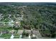 Aerial view of a home in a wooded neighborhood, marked with an arrow at 731 Red Coach Ave, Deltona, FL 32725
