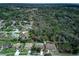 An aerial view of a neighborhood with tree coverage and well-maintained homes at 731 Red Coach Ave, Deltona, FL 32725