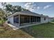 The rear exterior shows the back porch and a grassy area, offering a peaceful outdoor setting at 731 Red Coach Ave, Deltona, FL 32725