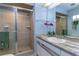 Well-lit bathroom featuring a shower stall and vanity with modern fixtures at 731 Red Coach Ave, Deltona, FL 32725