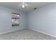 This cozy bedroom features soft carpeting, a window, and a ceiling fan at 731 Red Coach Ave, Deltona, FL 32725