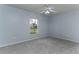 The bedroom features a window, carpet, and ceiling fan at 731 Red Coach Ave, Deltona, FL 32725