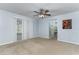 Bedroom with sliding door access to outdoors, view to en-suite bathroom, and carpeted floors at 731 Red Coach Ave, Deltona, FL 32725