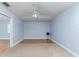 Spacious bedroom with light blue walls, fan, carpet and wood-look flooring at 731 Red Coach Ave, Deltona, FL 32725