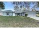 Charming single-story home featuring a manicured lawn and attached two-car garage at 731 Red Coach Ave, Deltona, FL 32725