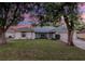 Charming single-story home with mature trees and a well-maintained lawn at dusk at 731 Red Coach Ave, Deltona, FL 32725