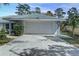 Exterior view of attached garage with a white door and driveway at 731 Red Coach Ave, Deltona, FL 32725