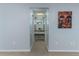This hallway has carpet and a view into the vanity area and bathroom beyond at 731 Red Coach Ave, Deltona, FL 32725