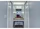 Hallway with built-in vanity and mirror leading to a bedroom, creating a functional and stylish space at 731 Red Coach Ave, Deltona, FL 32725