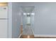 Inviting hallway featuring wood flooring and a plush gray runner, leading to other rooms at 731 Red Coach Ave, Deltona, FL 32725