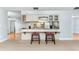 Open kitchen with breakfast bar, white cabinetry, and stainless steel appliances at 731 Red Coach Ave, Deltona, FL 32725