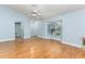 Bright living room features laminate flooring, a ceiling fan, and large windows for natural light at 731 Red Coach Ave, Deltona, FL 32725