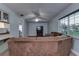 Cozy living room featuring a large window, ceiling fan, and comfortable seating for a relaxing atmosphere at 731 Red Coach Ave, Deltona, FL 32725