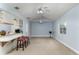 Open living room featuring a breakfast bar, ceiling fans, and natural light at 731 Red Coach Ave, Deltona, FL 32725