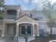 Tan two-story building with two front doors, balconies, and a small yard at 1223 Arbor Lakes Cir, Sanford, FL 32771