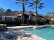 Community pool with lounge chairs and palm trees at 1223 Arbor Lakes Cir, Sanford, FL 32771