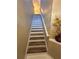 Modern staircase with wood-look treads and white risers leading to the upper level at 1223 Arbor Lakes Cir, Sanford, FL 32771