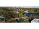Aerial view of a tree-covered lot with a home outlined in red and a view of the city at 1235 19Th St, Orlando, FL 32805