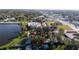 Aerial view of property outlined in red, neighbored by trees, grassy areas, and a pond, with commercial zoning in the distance at 1235 19Th St, Orlando, FL 32805