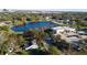 Aerial view of the property outlined in red, near a lake with surrounding trees and commercial buildings at 1235 19Th St, Orlando, FL 32805