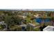 Aerial view featuring a serene neighborhood with a pond, trees, and the cityscape in the backdrop, a charming residential retreat at 1235 19Th St, Orlando, FL 32805