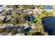 Aerial shot of homes neighboring a tranquil pond, surrounded by lush trees, creating a peaceful community ambiance at 1235 19Th St, Orlando, FL 32805