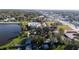 Aerial view showcases homes adjacent to tranquil lake, surrounded by trees, with business district nearby at 1235 19Th St, Orlando, FL 32805