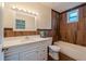Bathroom featuring wood-look tile, modern vanity, and a shower-tub combination with a window at 1235 19Th St, Orlando, FL 32805