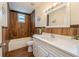 Bathroom featuring wood-look tile, modern vanity, and a shower-tub combination with a window at 1235 19Th St, Orlando, FL 32805